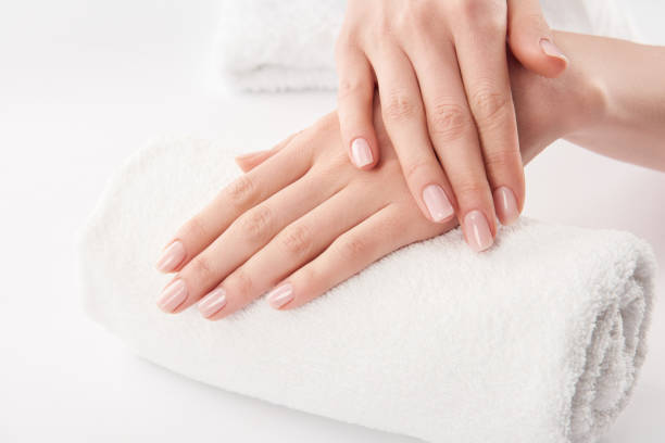 istock Partial view of female hands on terry towel on white background 1126565387