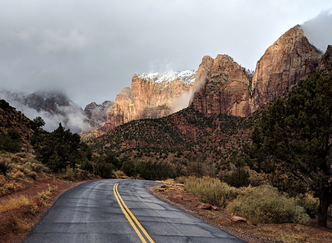 Snow on peaks and clearing clouds on scenic road in Zion National Park Utah