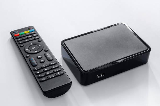 iptv box and remote controller. modern multimedia device for viewing television via the internet, multimedia player and control panel. - remote television movie box imagens e fotografias de stock