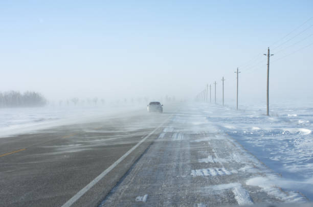 istock Car on Winter Road with Drifting snow 1126572048