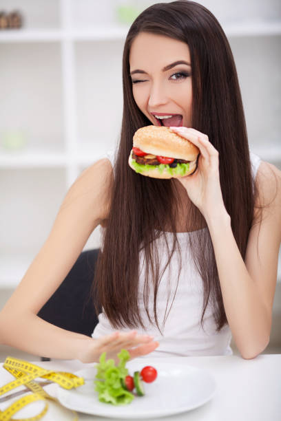 istock Choose between junk food versus healthy diet 1126572110