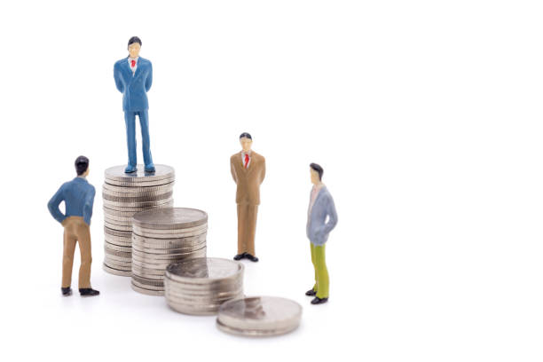istock Miniature businessman and coins on white background 1126573528