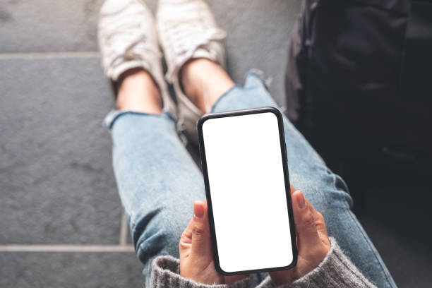 istock a woman holding black mobile phone with blank desktop screen 1126578853
