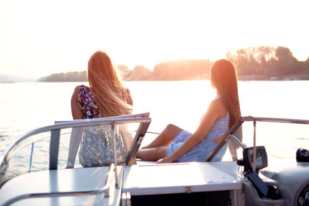 istock Two girls hanging out on a private yacht deck at sunset. 1126579119