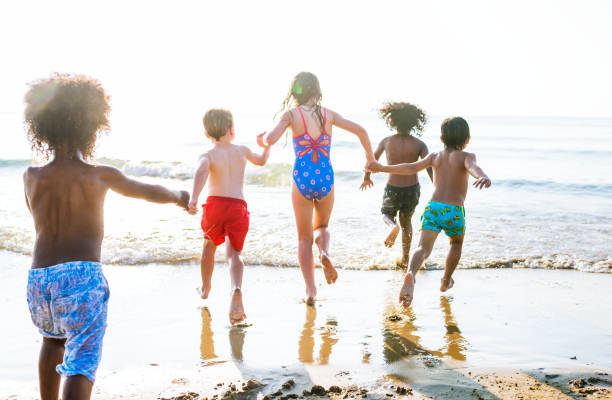 istock Kids running at the beach 1126581292