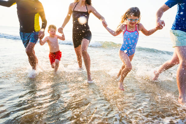 istock Family playing at the beach 1126581378