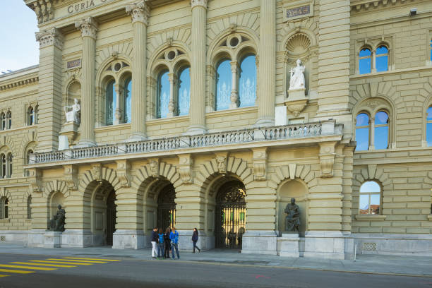 Facade of the Federal Palace building in the city of Bern, Switzerland Bern, Switzerland - November 2, 2014: facade of the Federal Palace building, people in front of it. The Federal Palace (German: Bundeshaus) is the building housing the Swiss Federal Assembly and the Federal Council. bundeshaus stock pictures, royalty-free photos & images