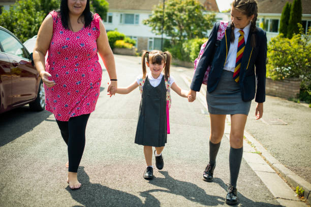 istock Mother and daughters on the way to school 1126588177