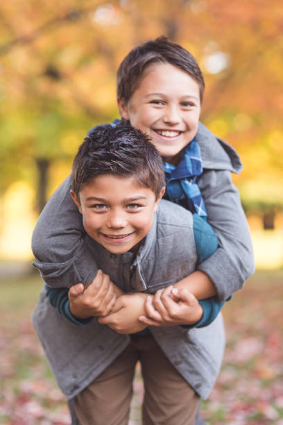 istock Two elementary-age boys walk to school through the park 1126588849
