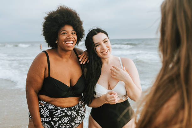 istock Cheerful beautiful plus size women at the beach 1126589672