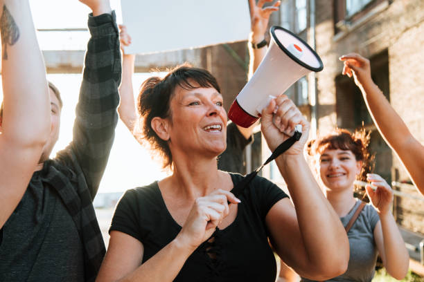 istock Joyful protesters marching through the city 1126590386