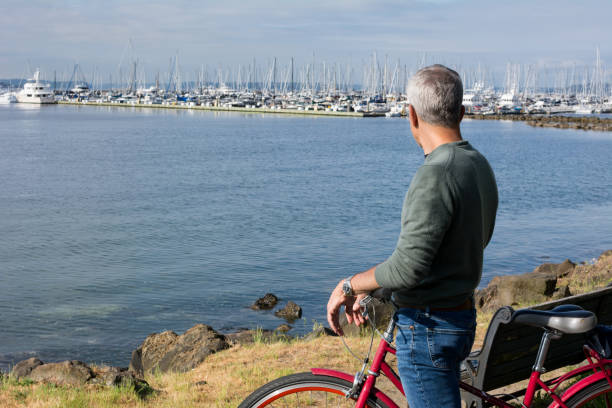 istock Senior Man Biking Near Water 1126592324