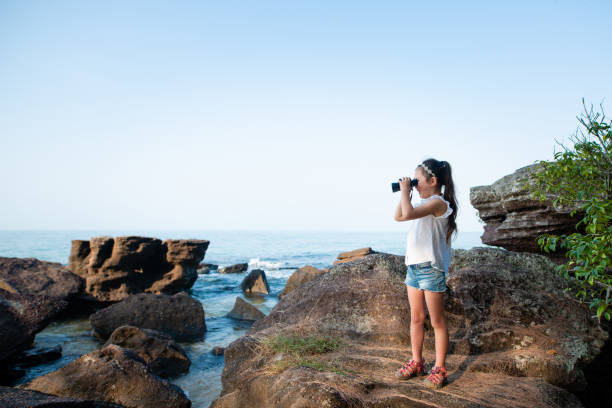 istock Girl using binoculars in the sea 1126598475