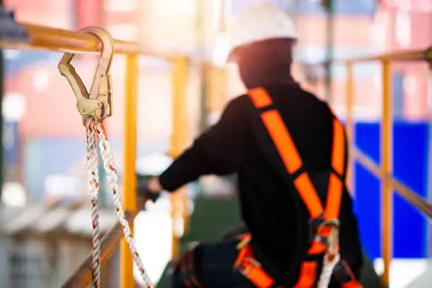 Photo of Construction worker wearing safety harness