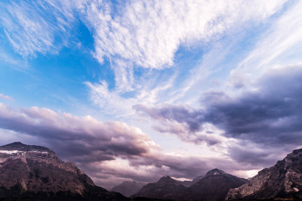 Sunlight lights the mountain peaks at sunset, Waterton Lakes National Park, Alberta, Canada.