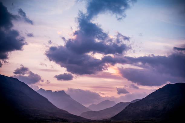 Sunlight lights the mountain peaks at sunset, Waterton Lakes National Park, Alberta, Canada.