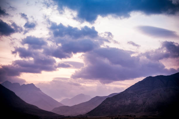 Sunlight lights the mountain peaks at sunset, Waterton Lakes National Park, Alberta, Canada.