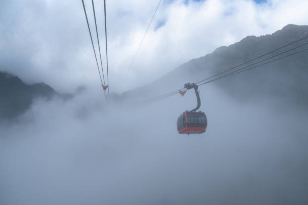 istock The cable car to mountain top with low clouds and mountain view 1126599511