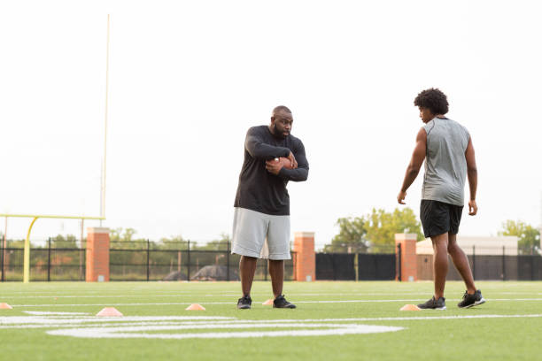 istock American Football coach training a young athlete. 1126600774