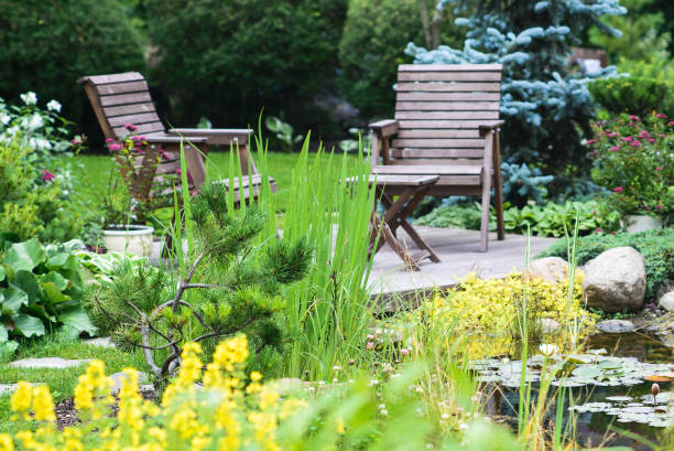 Garden furniture near the pond stock photo