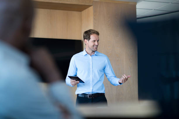 istock Smiling professional giving presentation in meeting 1126612016