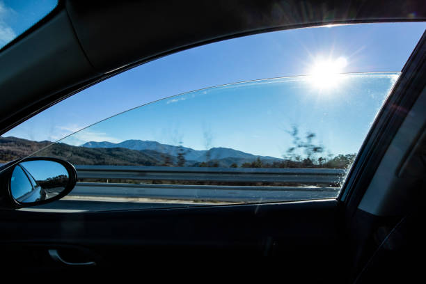 istock Sun flare shining thru a right window car in movement 1126612639