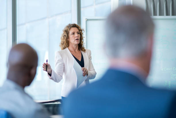 istock Mature professional giving presentation in meeting 1126612704