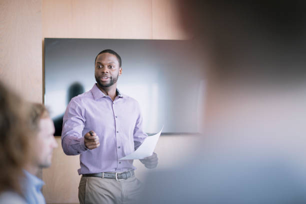 istock Young businessman with document in meeting 1126612816