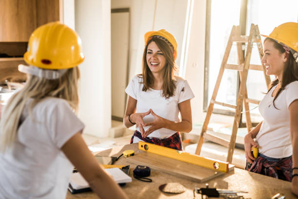 istock Team of female construction workers communicating during home renovation process. 1126613565