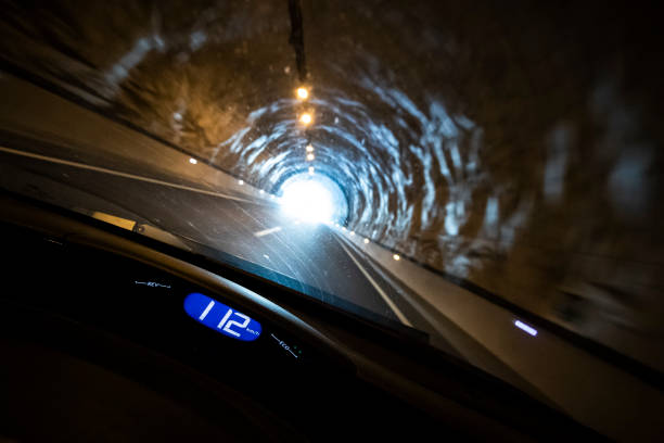 istock Driving fast a car inside a dark tunnel from an indoor driver perspective 1126613918