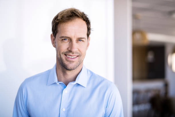 istock Confident businessman smiling in new office 1126613955