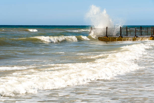 istock Seascape with stormy waves and old stone pier. Water splashes 1126614667