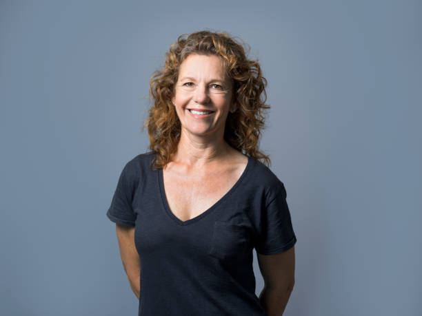 istock Businesswoman smiling against gray background 1126614681