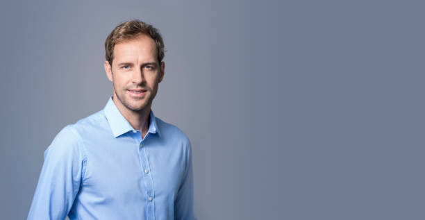 istock Confident businessman smiling over gray background 1126614827