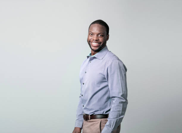 istock Young businessman smiling over gray background 1126614897
