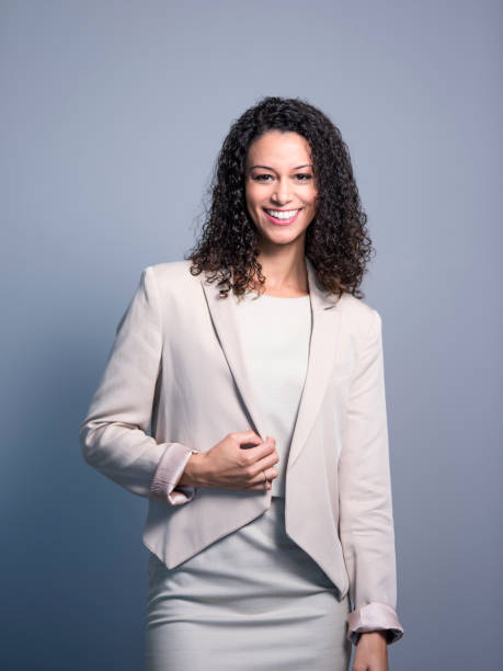 istock Smiling executive in blazer over gray background 1126615082