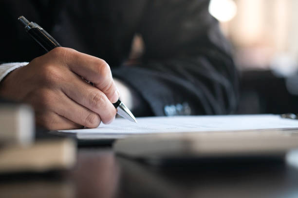 istock Businessman analyzing investment charts and pressing calculator buttons over documents. Accounting Concept. 1126615172