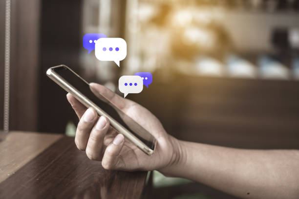 istock Women hand using smartphone typing, chatting conversation in chat box icons pop up. Social media maketing technology concept.Vintage soft color tone background. 1126617558