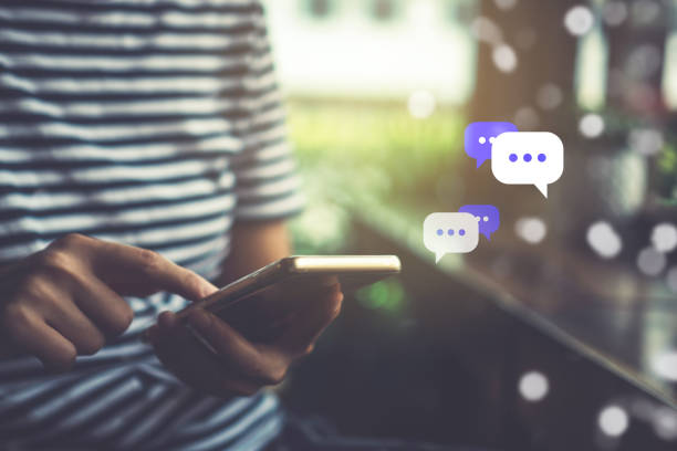 istock Women hand using smartphone typing, chatting conversation in chat box icons pop up. Social media maketing technology concept.Vintage soft color tone background. 1126617563