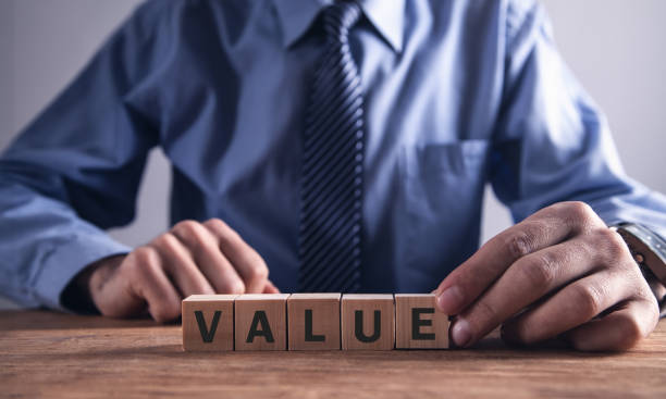 istock Man showing word Value with wooden blocks. 1126618653
