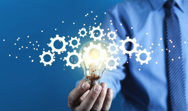 istock Man holding light bulb and gears mechanism. Concept of Idea, Imagination, Creativity 1126618656