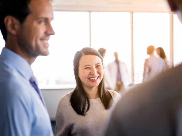 istock Smiling executive discussing with male coworkers 1126620106