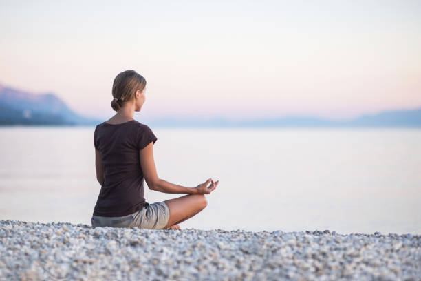 istock Woman is practicing yoga at sunset. Meditation and harmony concept 1126620214