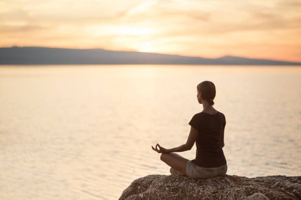 istock Woman is practicing yoga at sunset. Meditation and harmony concept 1126620216