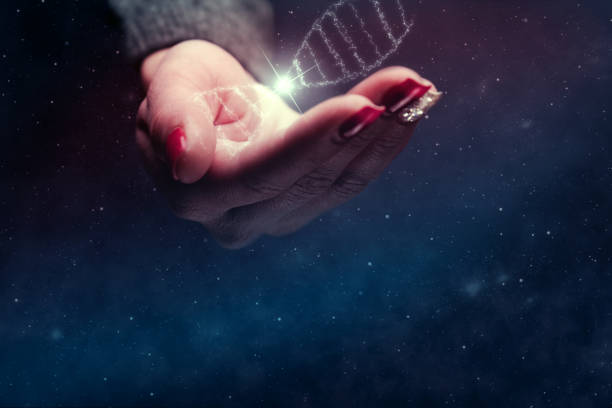 istock Woman holding DNA molecule in palm. Nebula dust in infinite space. Mixed media. 1126621394