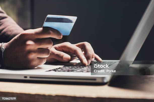 Man Shopping Online Using Laptop Computer And Credit Card Stock Photo - Download Image Now