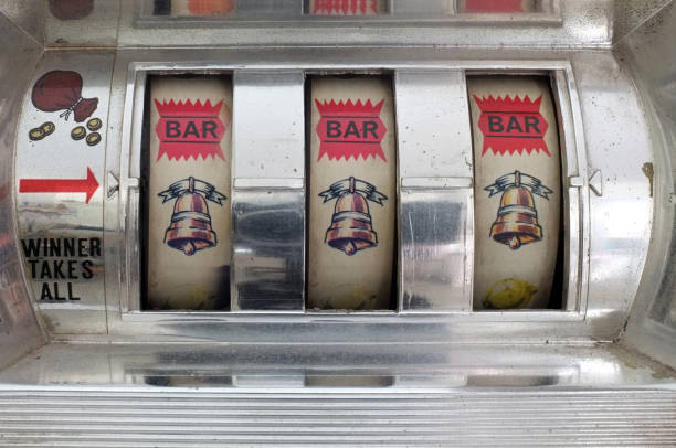istock Slot machine showing three golden bell symbols 1126621574
