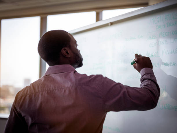 istock Young businessman writing strategies on whiteboard 1126621576