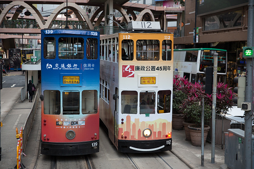 Hong Kong, Hong Kong - January 30, 2019: Double-decker trams move past Causeway Bay in Hong Kong. Many Passengers are inside the double-decker tram. Hong Kong has the world's largest operating fleet of double-decker trams.