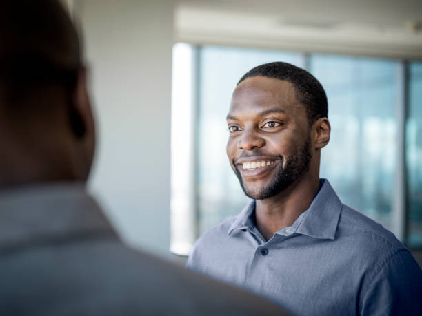 istock Smiling businessman with colleague in office 1126621763